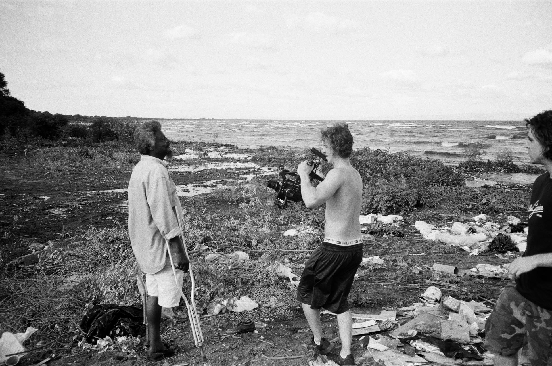 Marco Gilbert and Vincent Ruel-Cote from Les Gamins filming disabled man on beachside for Karim Ouellet music video of La Mer A Boire