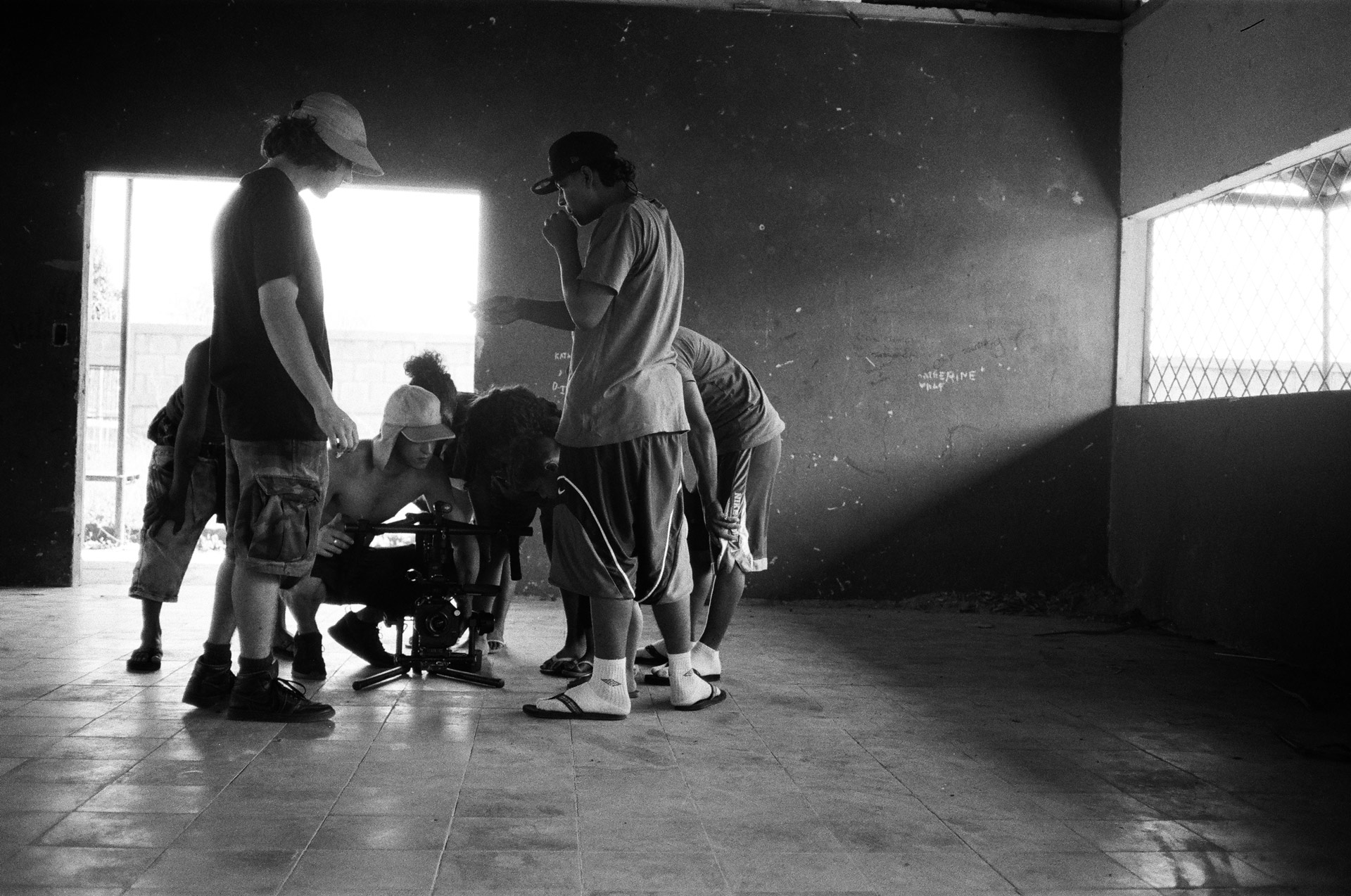 Vincent Ruel-Cote and Marco Gilbert from Les Gamins looking at camera with the crew crouching on the ground for singer Karim Ouellet music video of La Mer A Boire