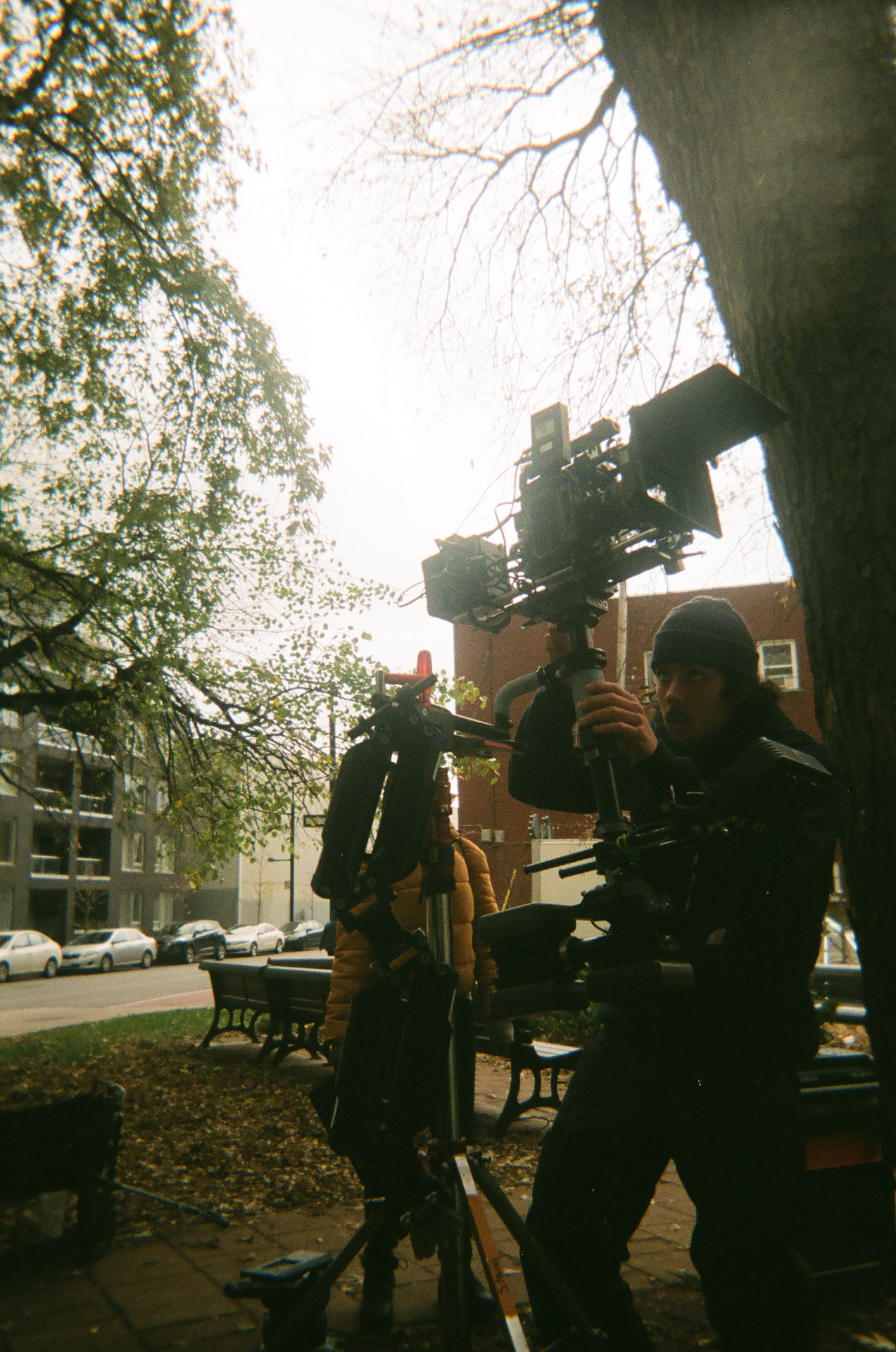 camera assistant filming with camera held up high in behind the scenes of TV series La Loi C'est La Loi filmed by Les Gamins for TV5 Unis