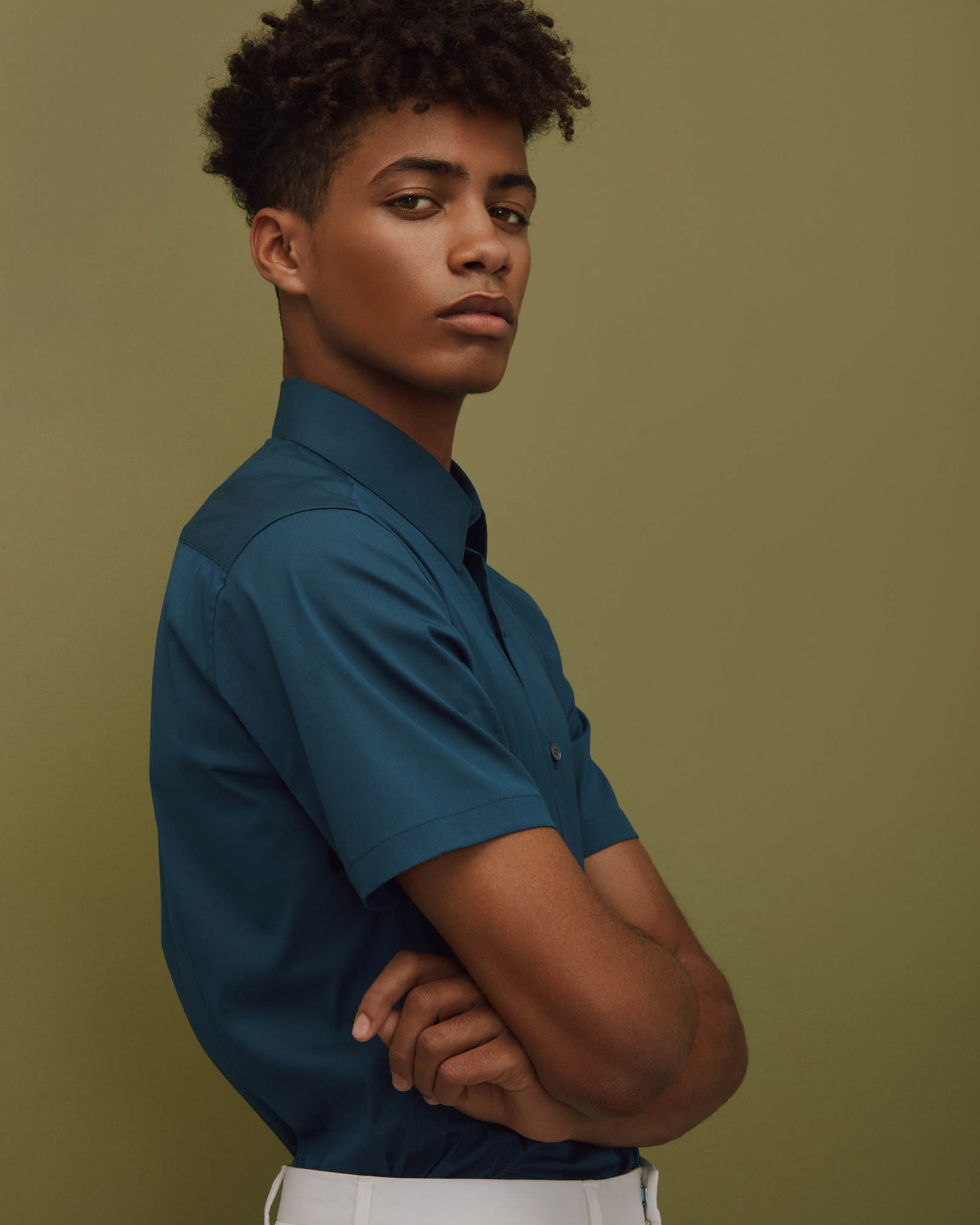 black man in dark blue shirt fullbody on green background by Maxyme G Delisle for The Ones 2 Watch