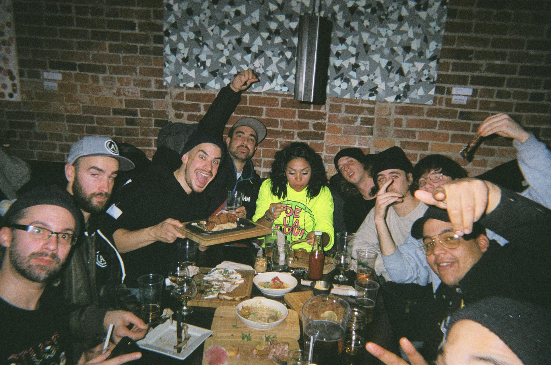 team of L'Osstidfilm documentary filmed by Vincent Ruel-Cote from Les Gamins about L'Osstidtour all eating together at restaurant smiling and laughing