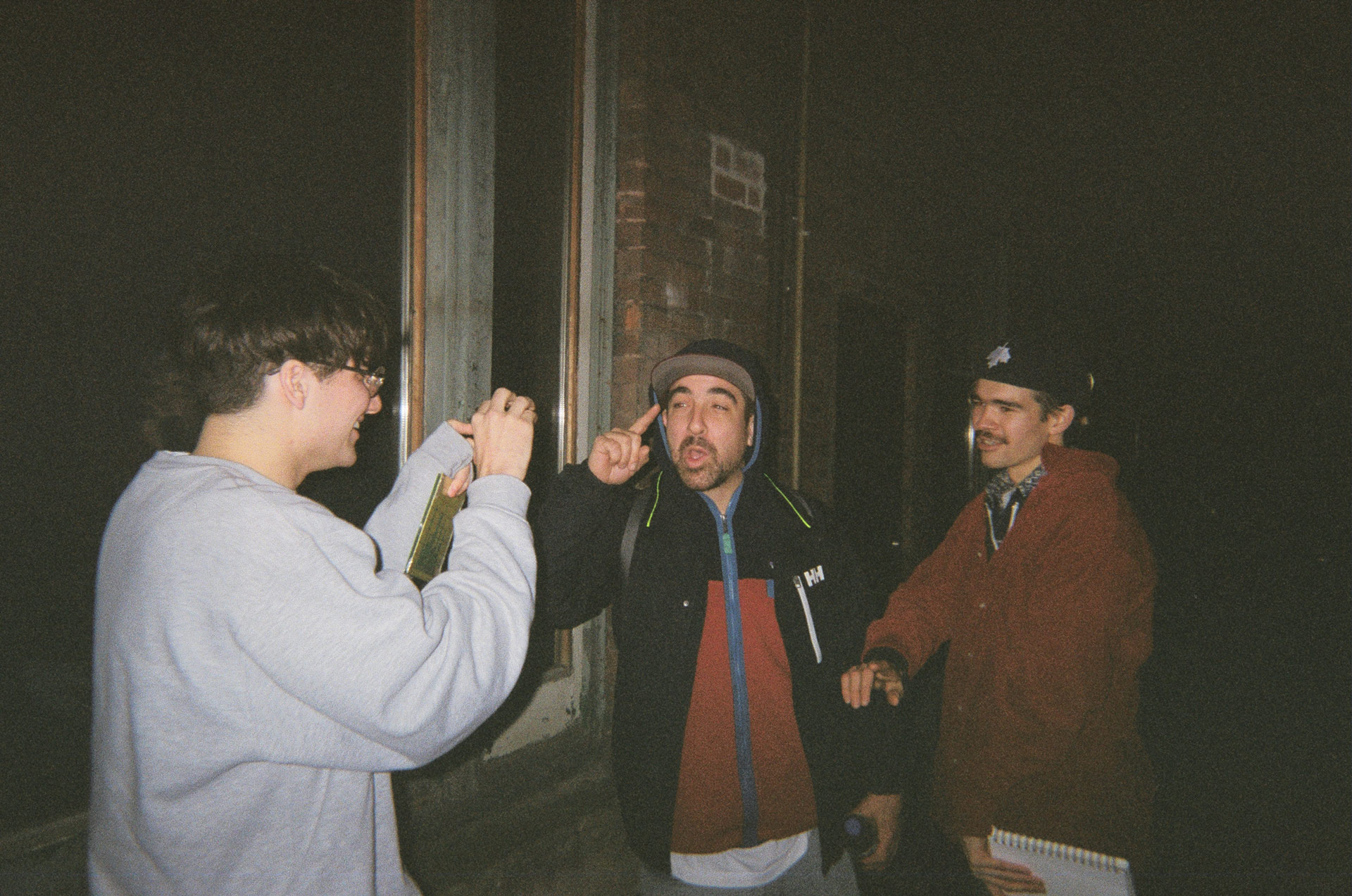 Alaclair Ensemble singer having fun in the street with two of his friends in behind the scenes of L'Osstidfilm documentary filmed by Vincent Ruel-Cote from Les Gamins about L'Osstidtour