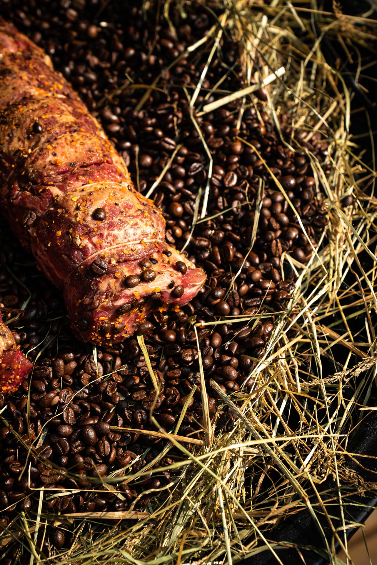 meat prepared chef Ted Reader slowly cooking over coffee beans and hay by Bruno Florin for Van Houtte 100th anniversary