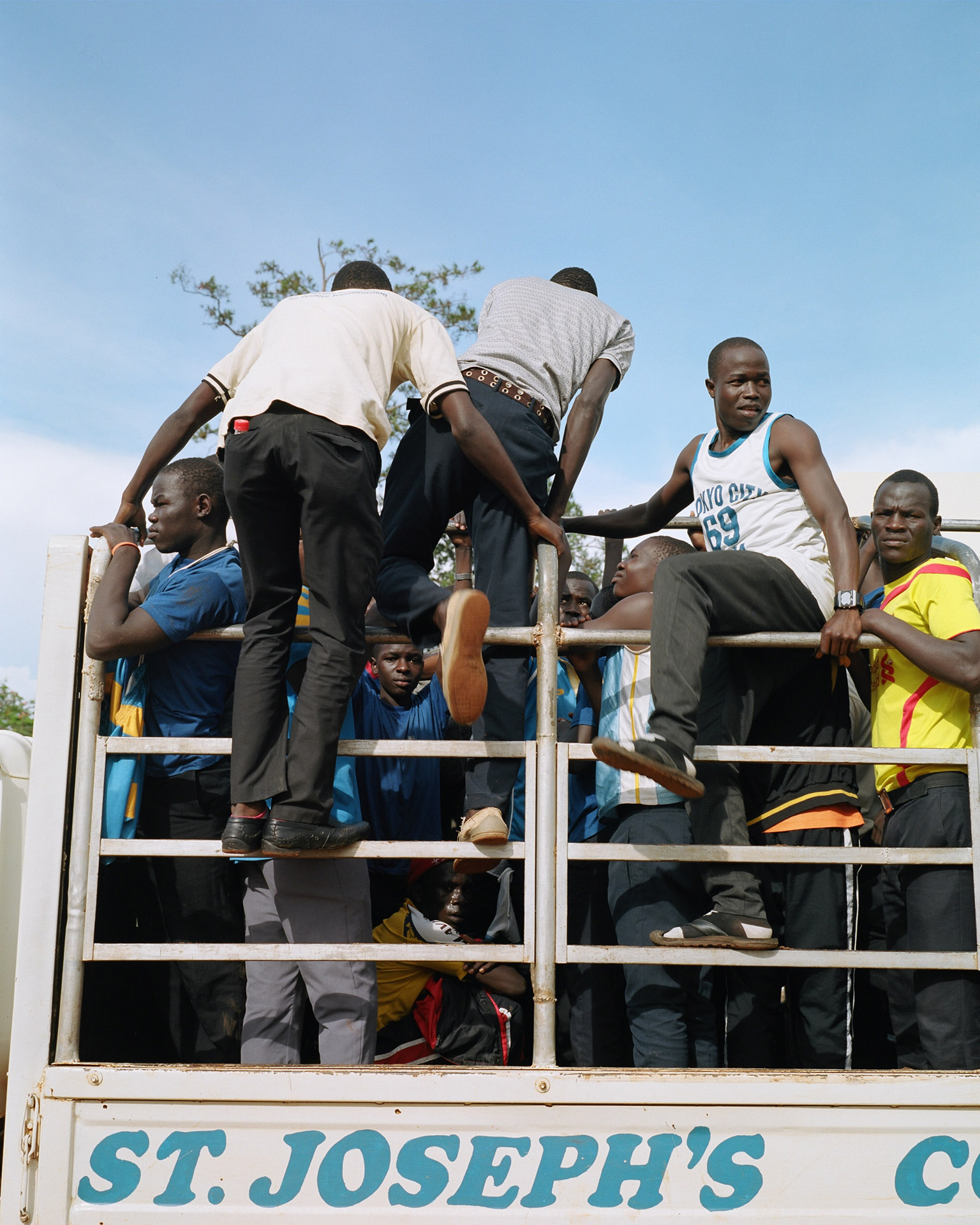 group of black men supporting soccer team by Alexi Hobbs in Uganda for Football for good with Sportsnet