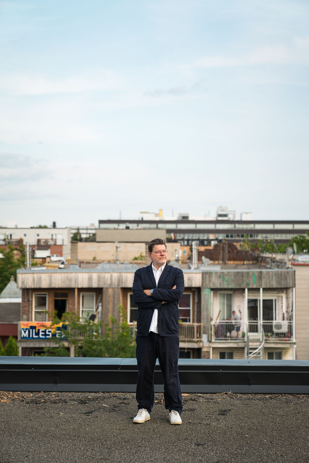 man on rooftop looking away by Bruno florin for mile-ex mille vies