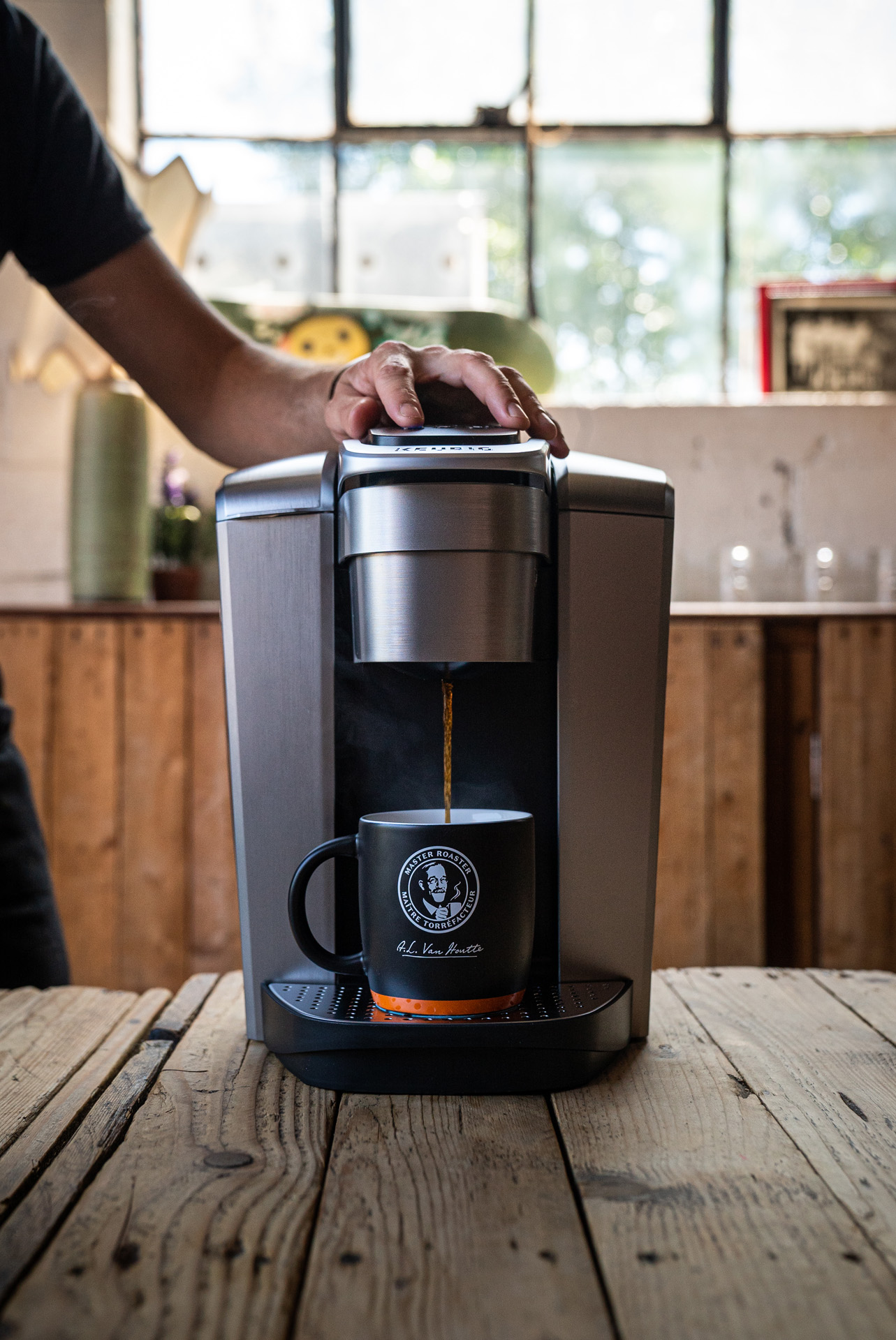 chef Sebastian Harrisson-Cloutier making a coffee with a Keurig machine in a Van Houtte branded cup by Bruno Florin for Van Houtte 100th anniversary