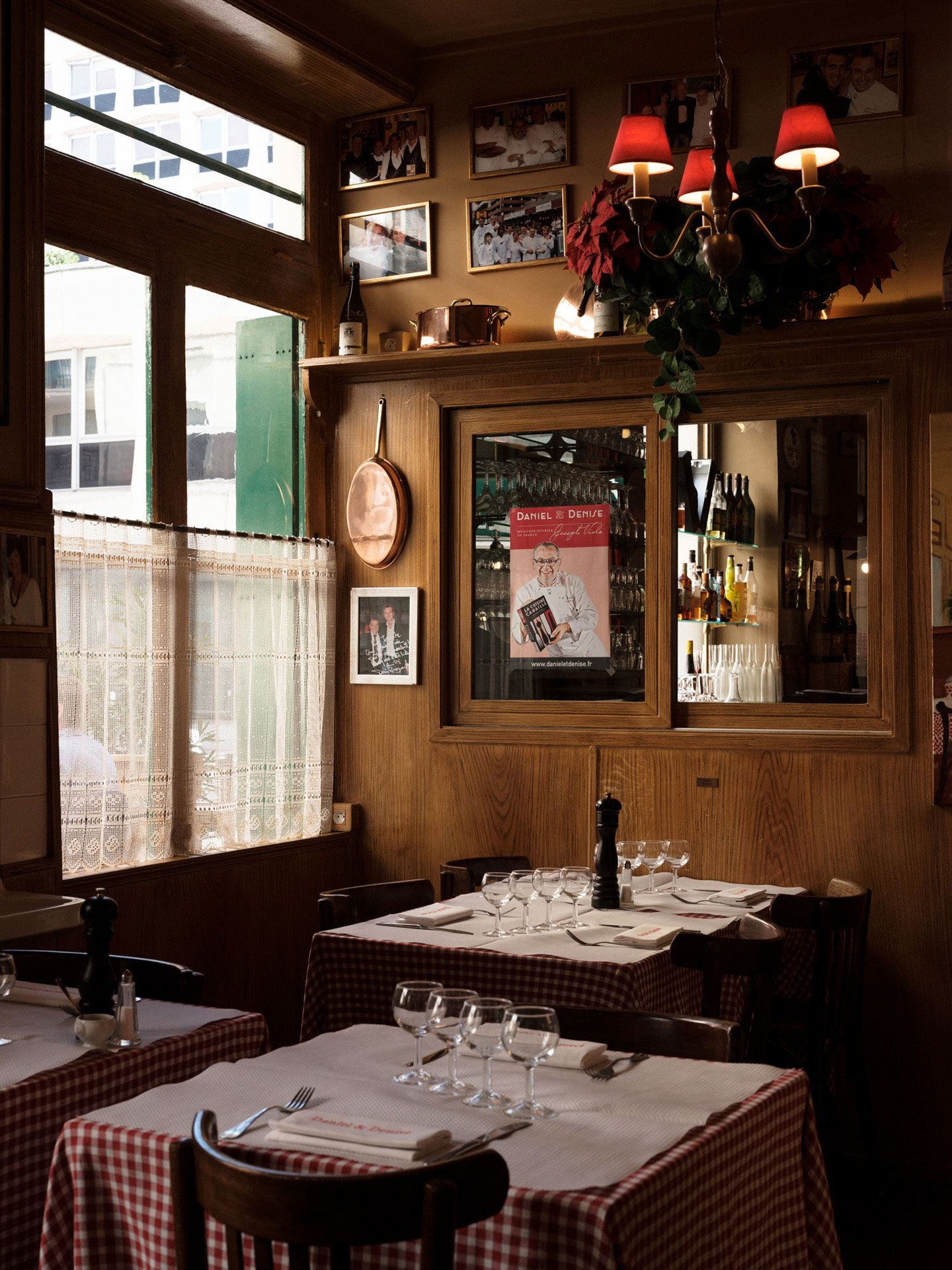 inside of a traditional french countryside restaurant with vichy tablecloth by Alexi Hobbs in Auvergne for Reflets de France