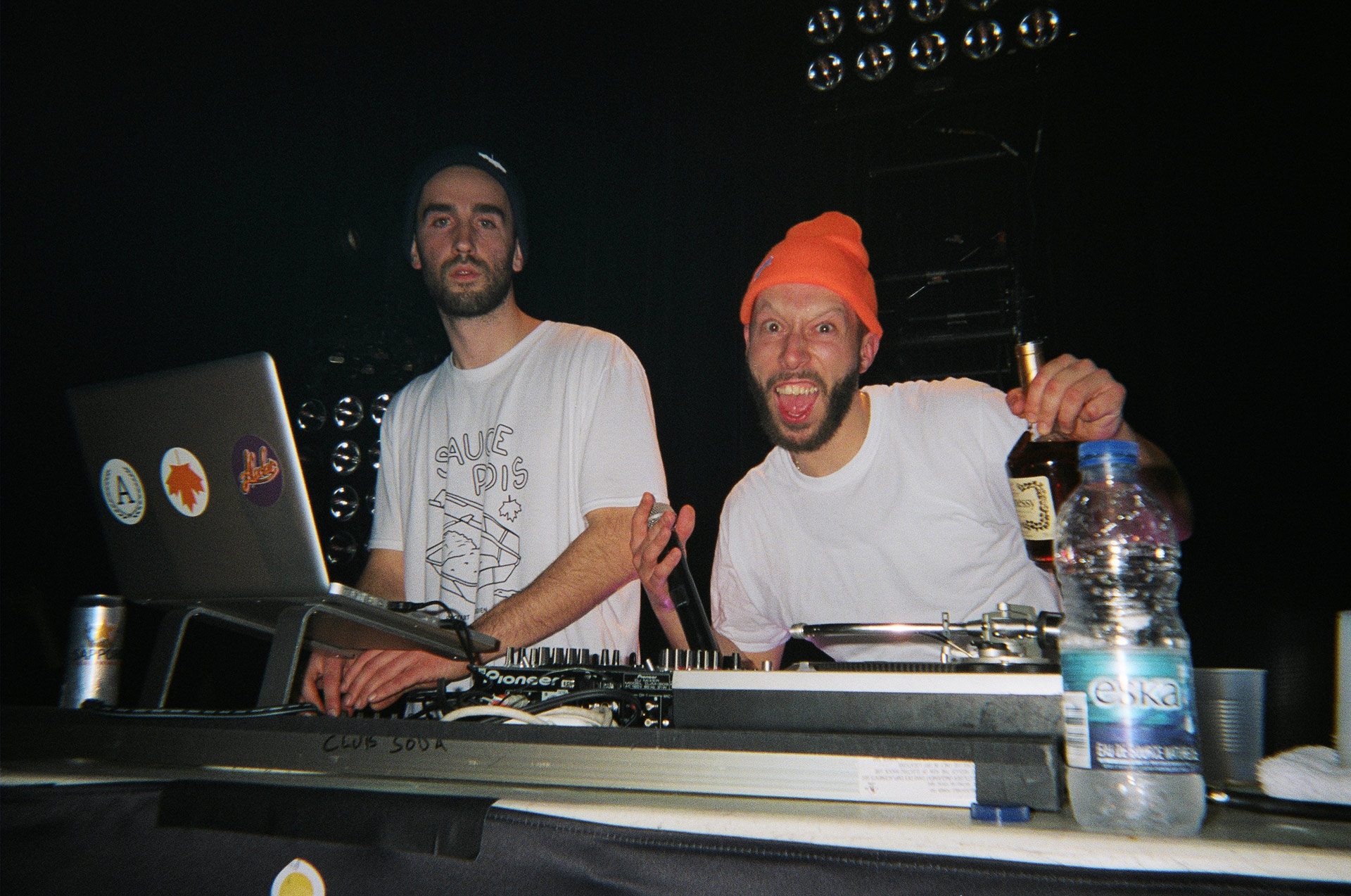 Alaclair Ensemble bandmates on the decks making faces and drinking Hennessy in behind the scenes of L'Osstidfilm documentary filmed by Vincent Ruel-Cote from Les Gamins about L'Osstidtour