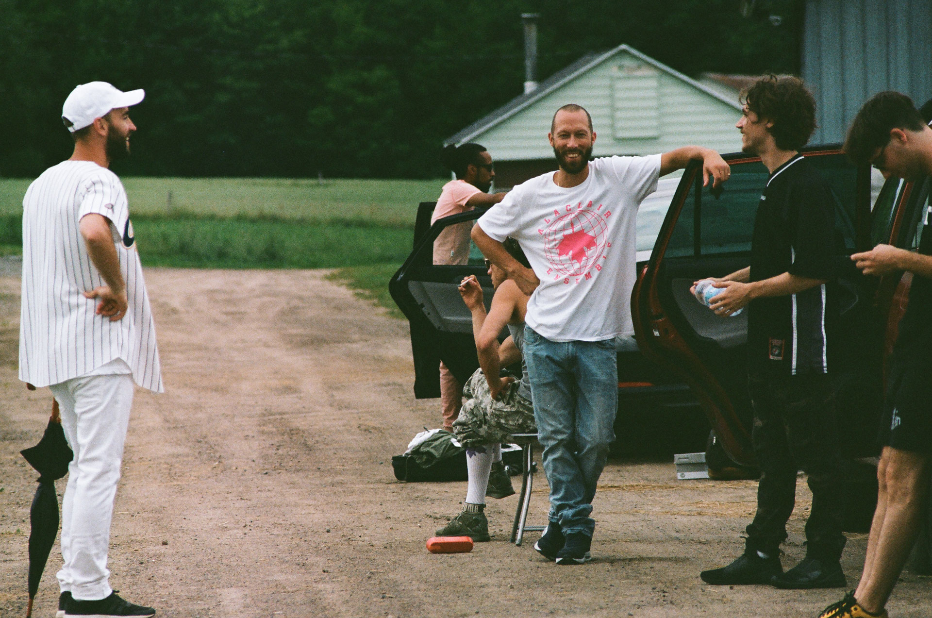 Alaclair Ensemble hip hop collective members waiting next to cars while shooting for music video Felix filmed by Les Gamins featuring rapper Souldia