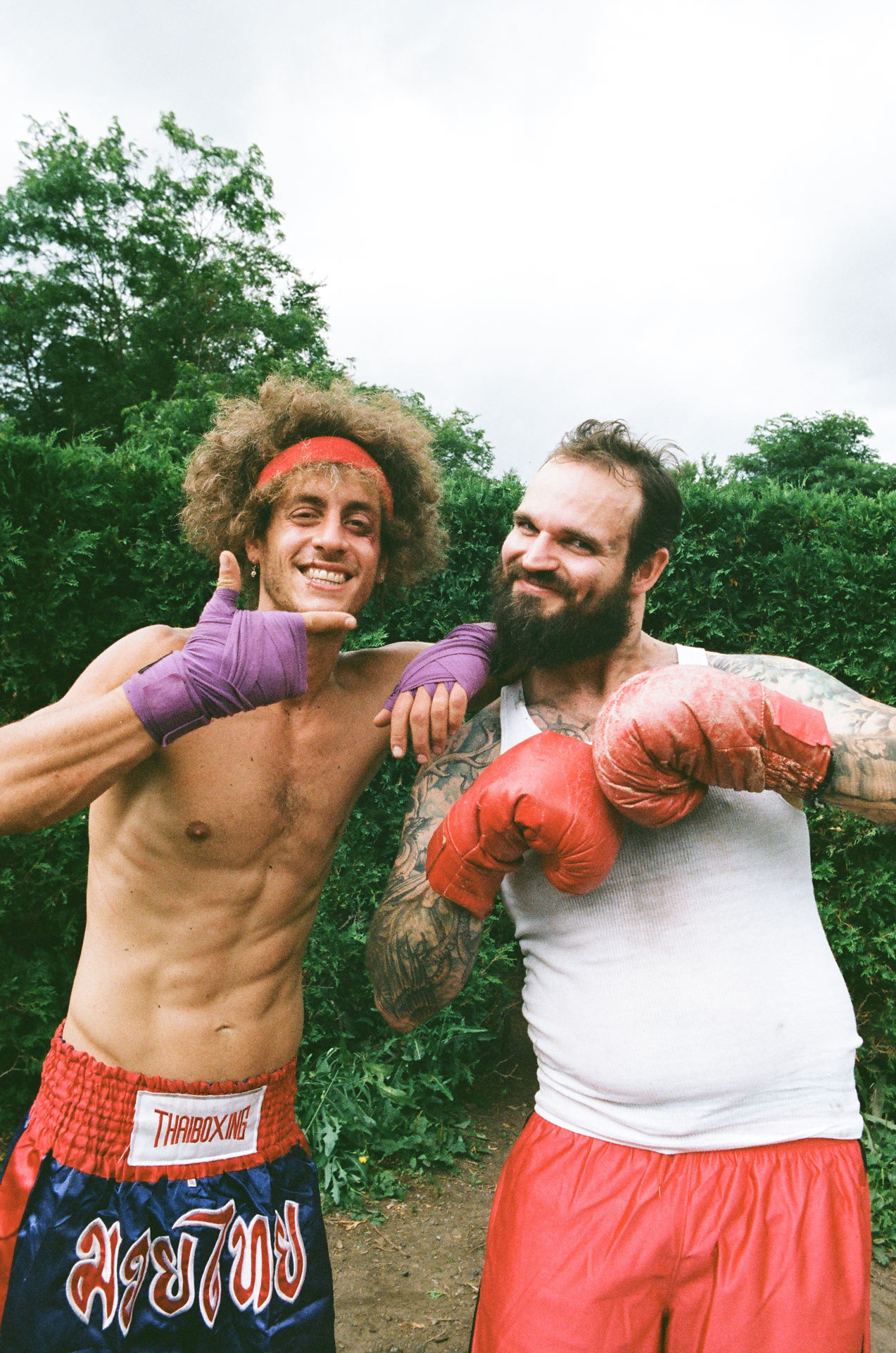 actor dressed as boxers looking beaten up smiling at camera for Alaclair Ensemble hip hop collective music video Felix filmed by Les Gamins featuring Souldia
