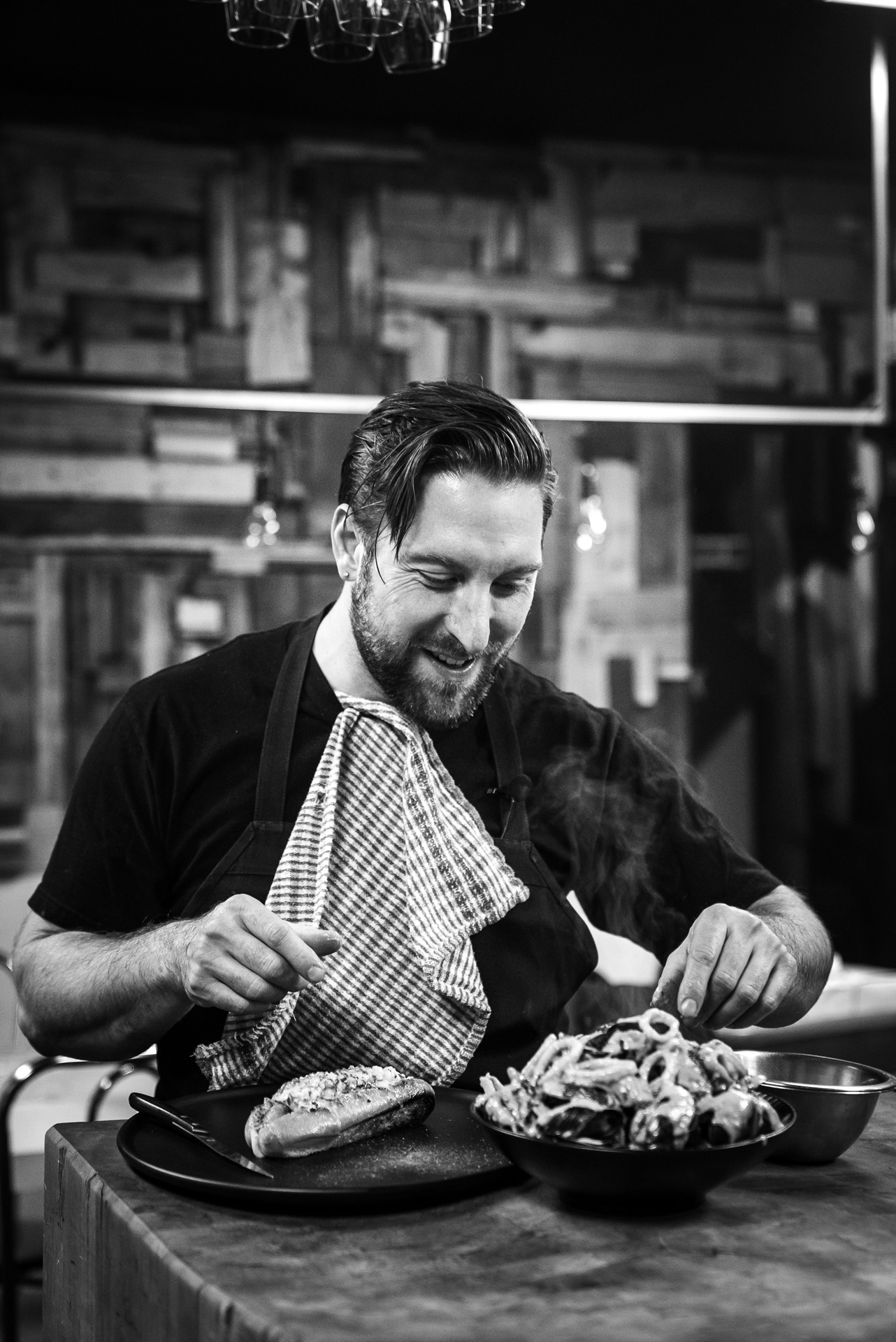 black and white portrait of Mile-Ex restaurant chef Gregory Paul about to eat by Bruno Florin