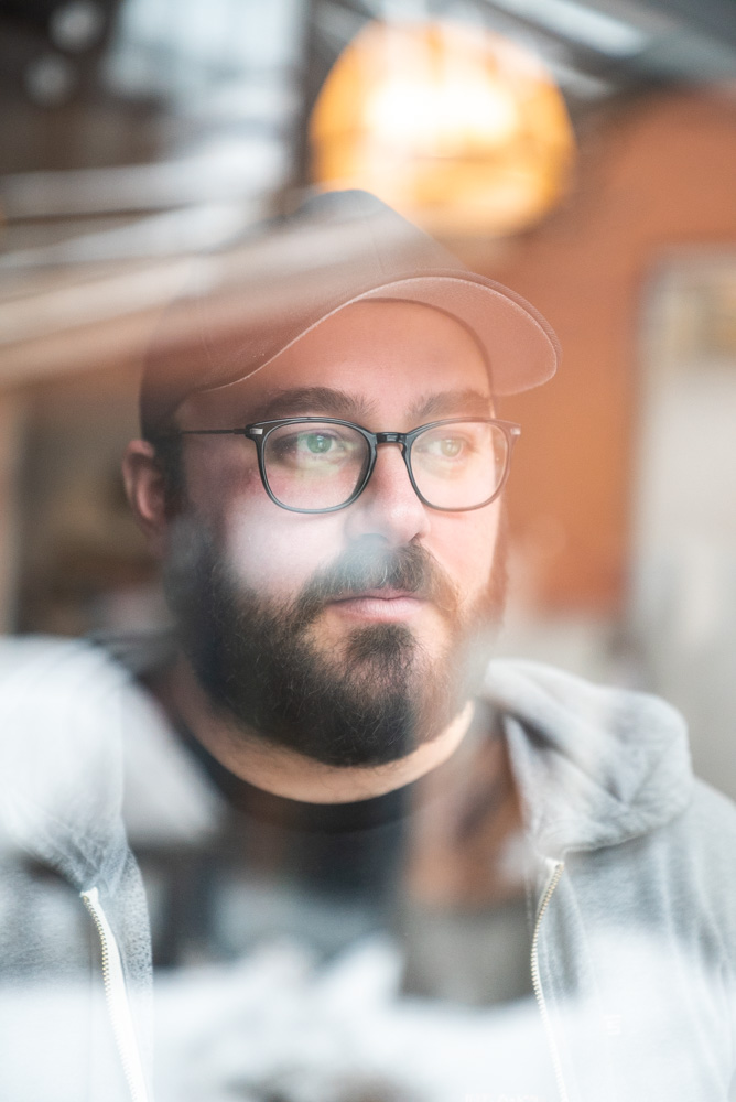 portrait of chef Simon Mathys of Manitoba restaurant through a window by Bruno Florin