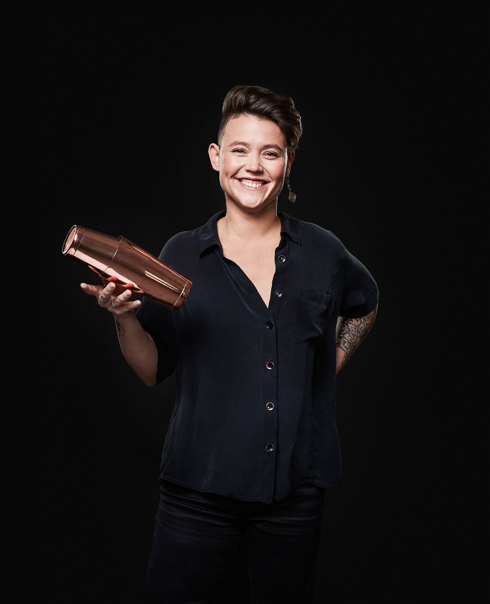 portrait of Dahpnée Vary Deshaies female mixologist holding a copper shaker by Jocelyn Michel for the Cathcart