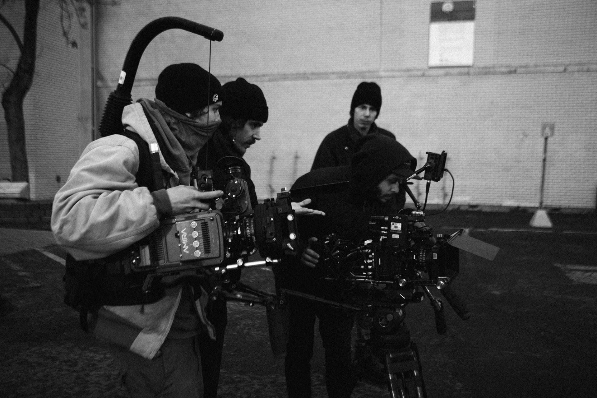 Vincent Ruel-Cote from Les Gamins checking footage screen with assistants in behind the scenes of TV series La Loi C'est La Loi with TV5 Unis