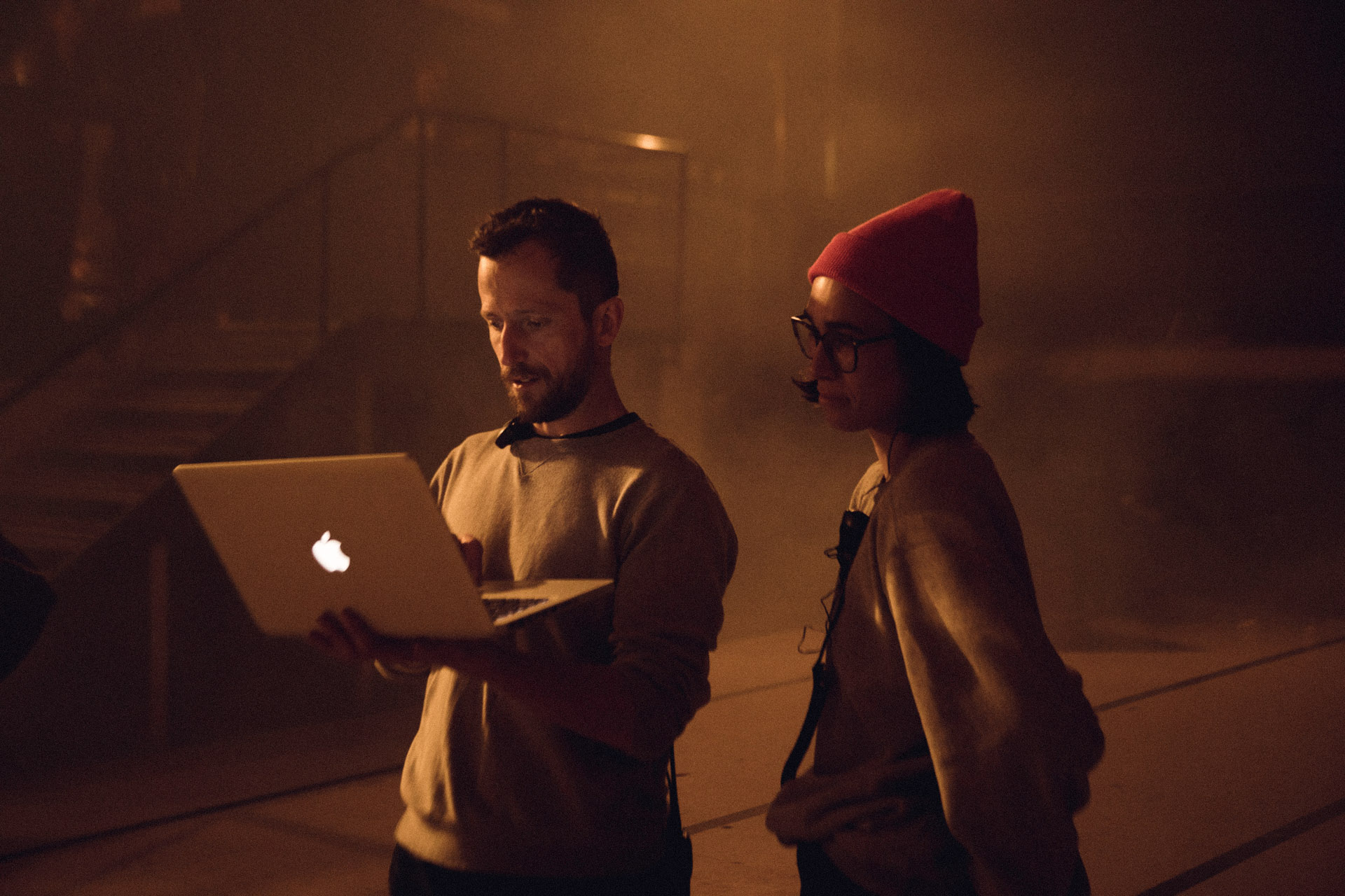 producers checking footage on computer standing up in behind the scenes of TV series La Loi C'est La Loi filmed by Les Gamins with TV5 Unis