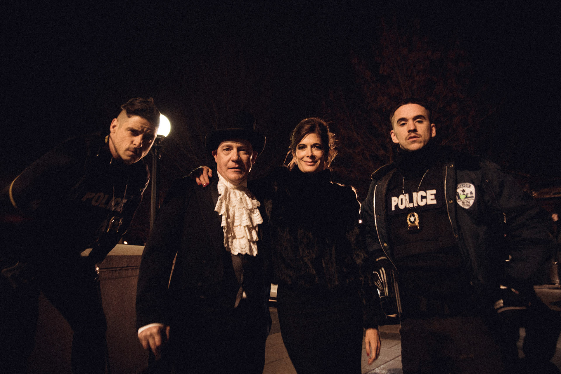 actors Hugolin Chevrette-Landesque and Emile Schneider dressed as cops with two of their co-actors posing for pictures in front of Marche Maisonneuve in behind the scenes for TV series La Loi C'est La Loi filmed by Les Gamins for TV5 Unis