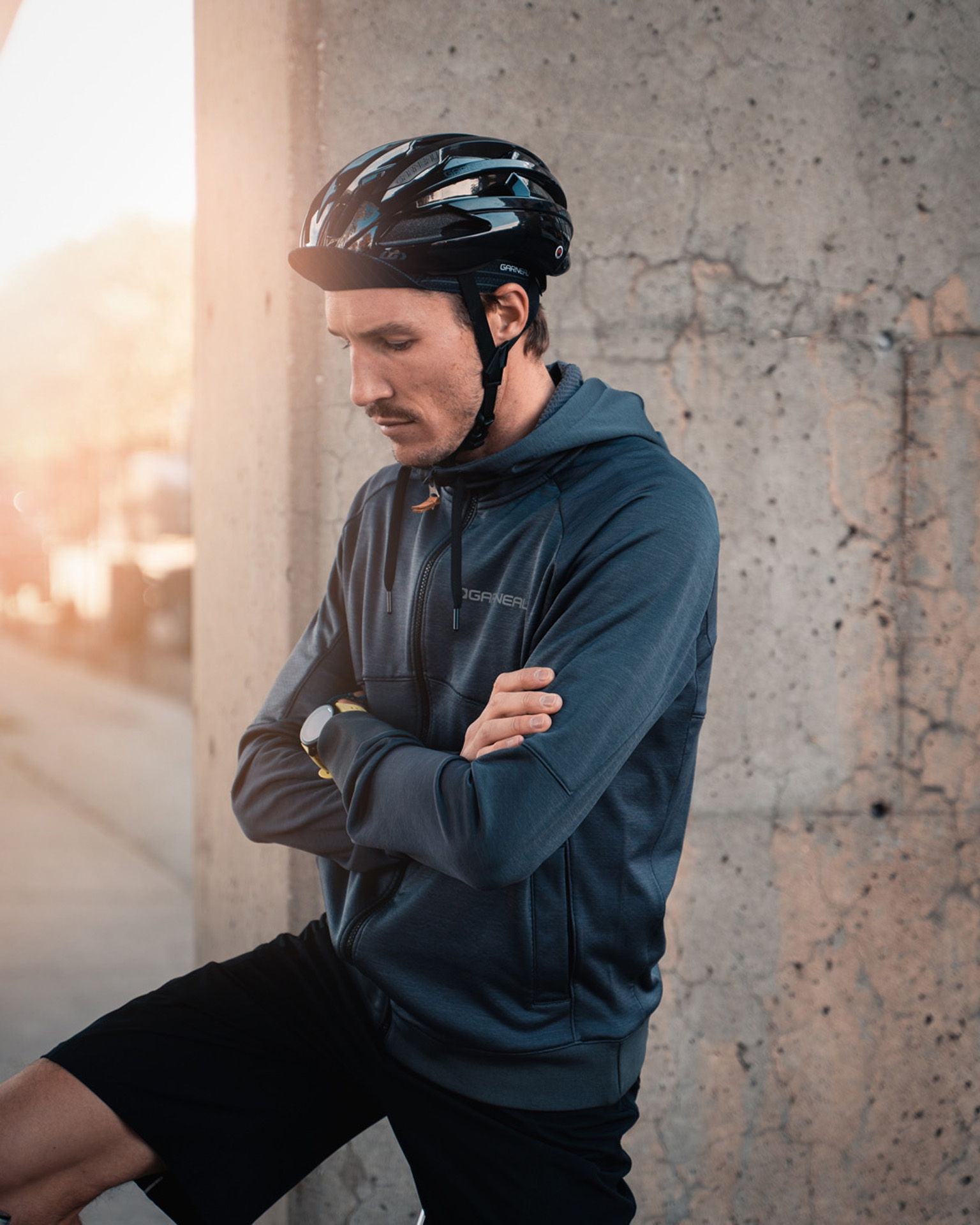 male model wearing bike helmet black shorts and dark blue jacket as Spring Summer 2020 campaign of Louis Garneau with artistic direction and styling by Studio TB