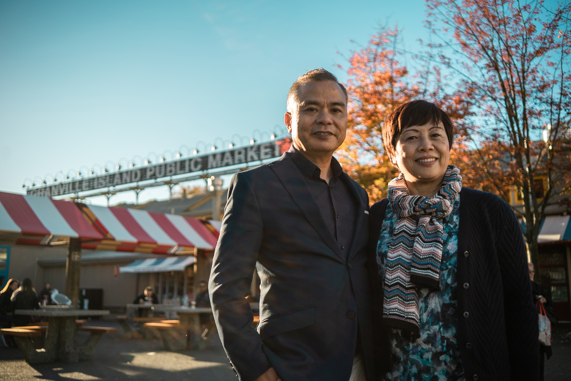 asian couple posing in front of public market in autumn by Bruno Florin for BDC Beyond Business with Cossette