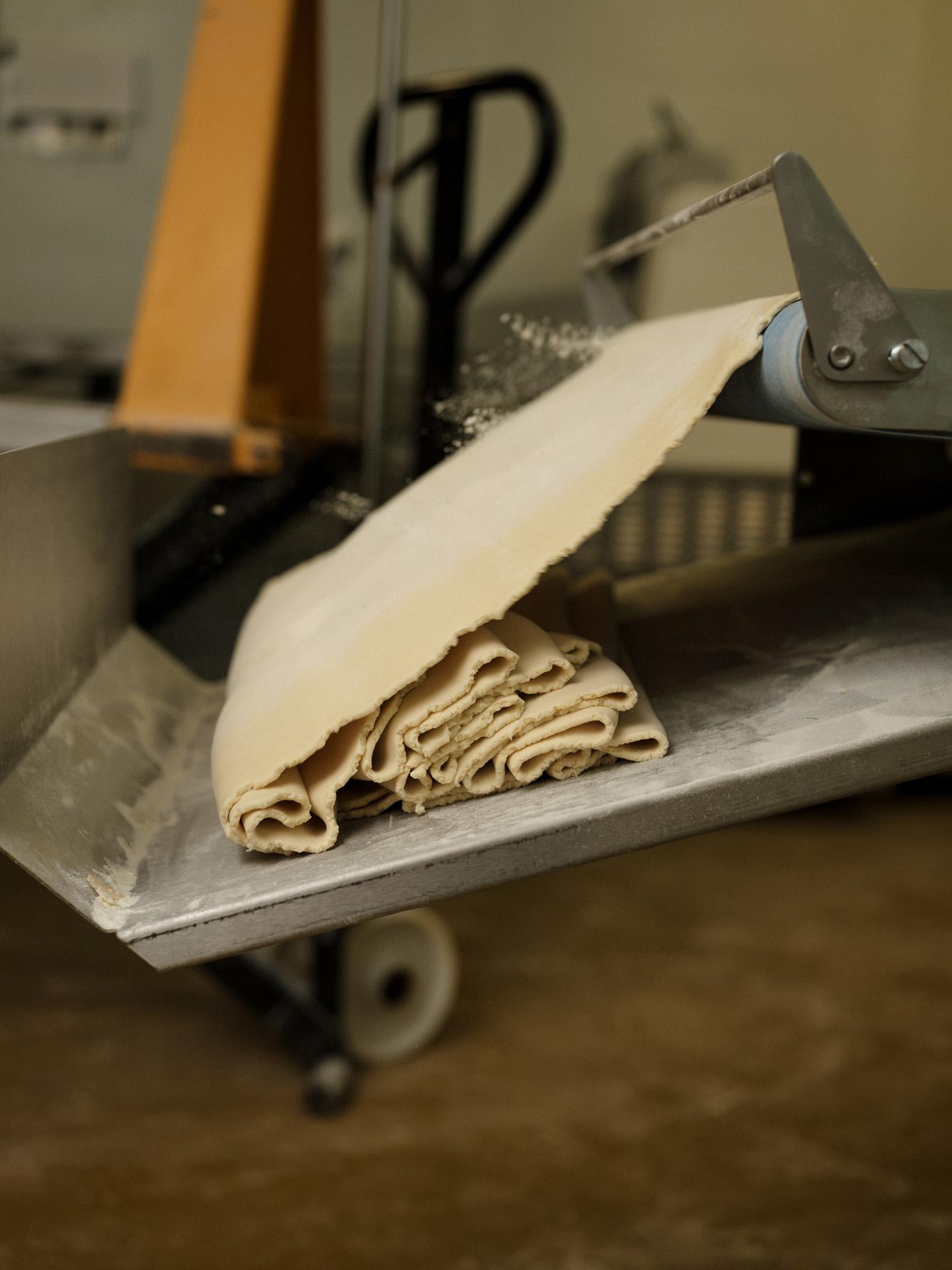 pasta dough going through machine to get thinned by Alexi Hobbs in Auvergne for Reflets de France
