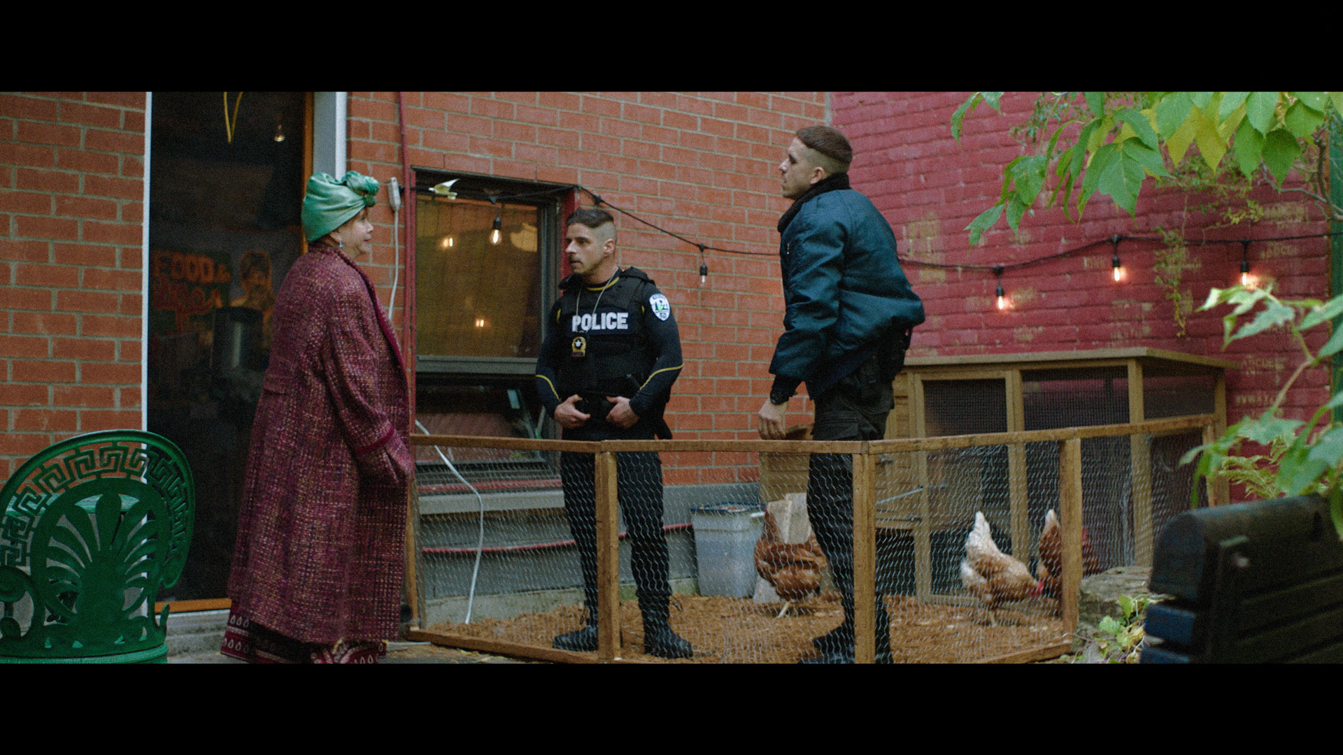 actors Hugolin Chevrette-Landesque and Emile Schneider posing as cops in a chicken coop for TV series La Loi C'est La Loi filmed by Les Gamins for TV5 Unis