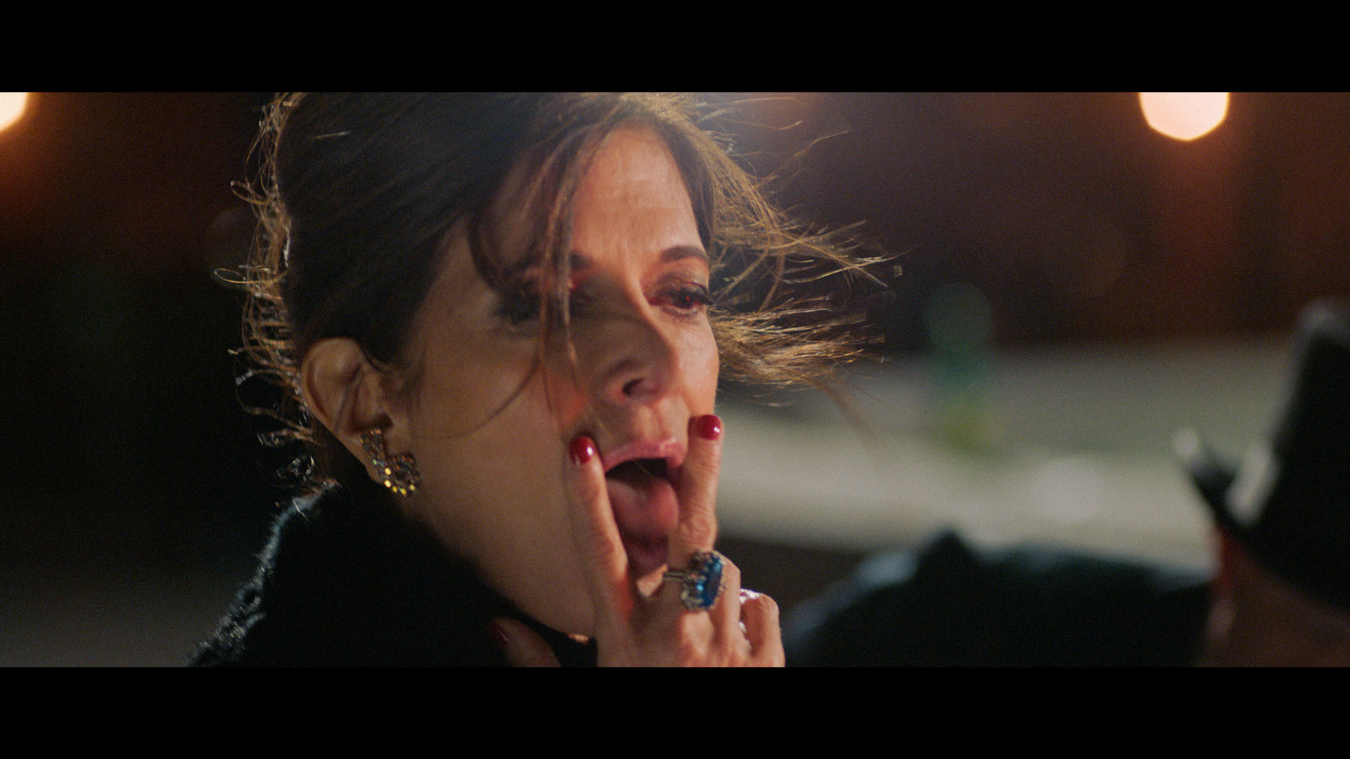 actress forming V with her fingers and sticking her tongue in between them with her hair in the wind for TV series La Loi C'est La Loi filmed by Les Gamins for TV5 Unis