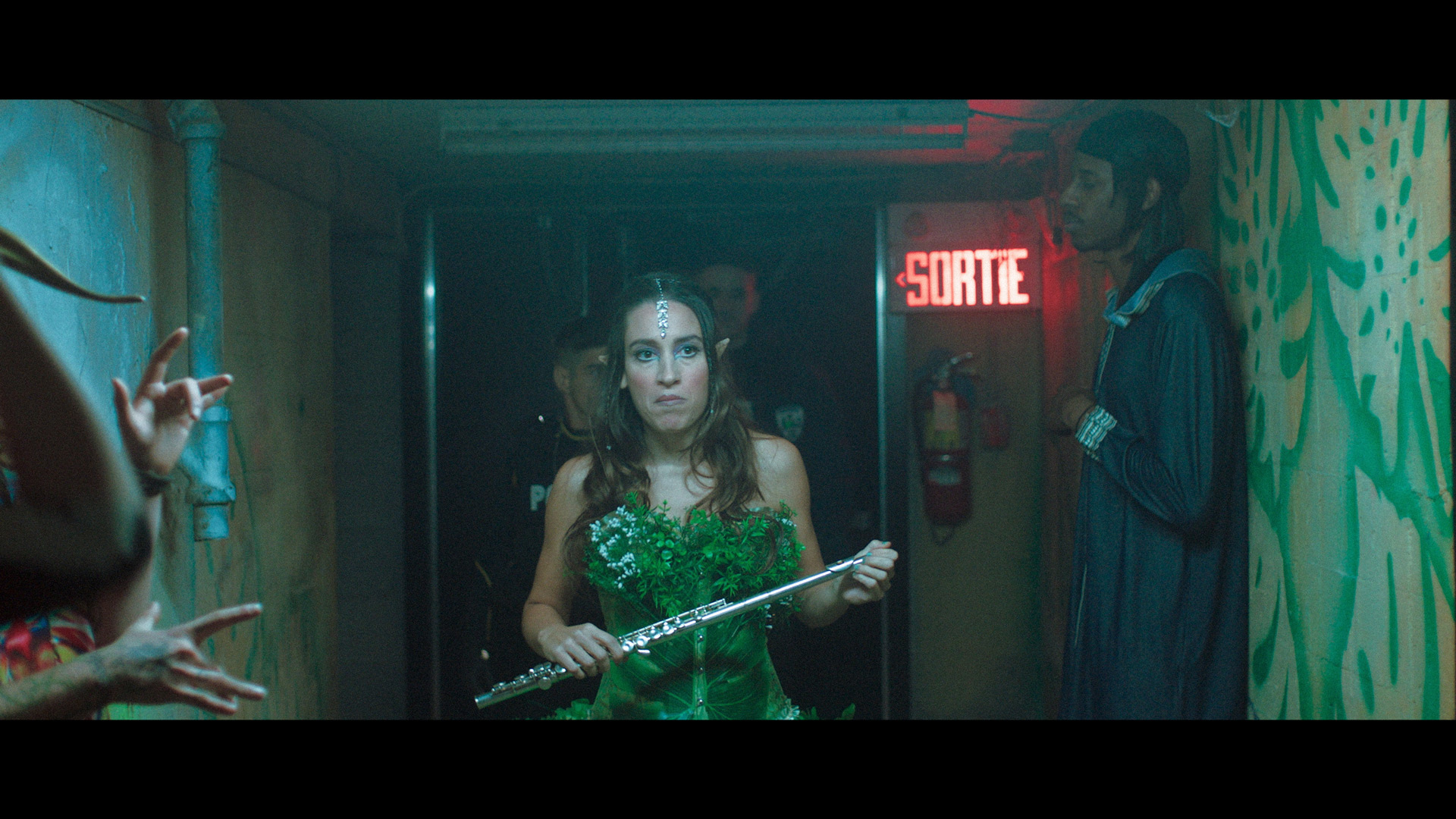 actress disguised as fairy with a flute walking in a corridor in TV series La Loi C'est La Loi filmed by Les Gamins for TV5 Unis
