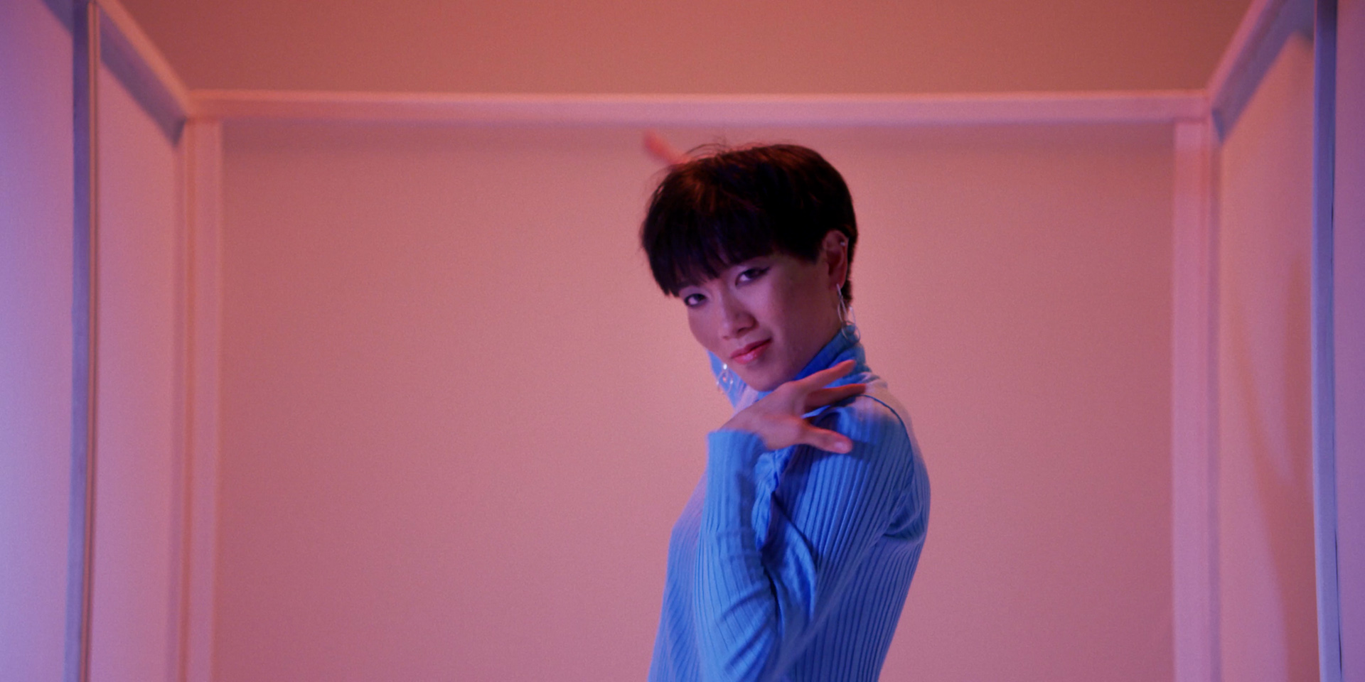 asian dancer in pink lighting on blue background by Simon Duhamel for Fabrikate