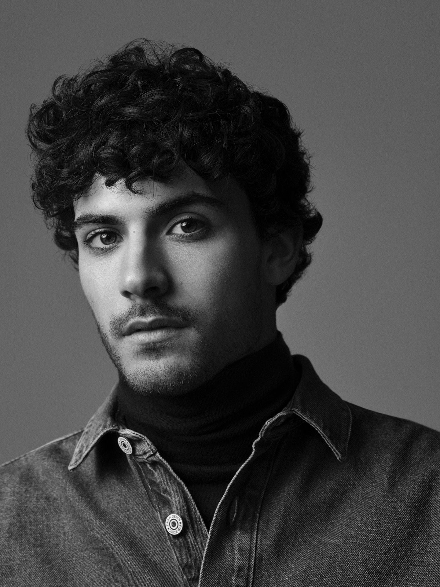 portrait of male model Adam looking straight at camera not smiling in black and white by Maxyme G Delisle with artistic direction from Studio TB for Jean-Paul Fortin Fall collection