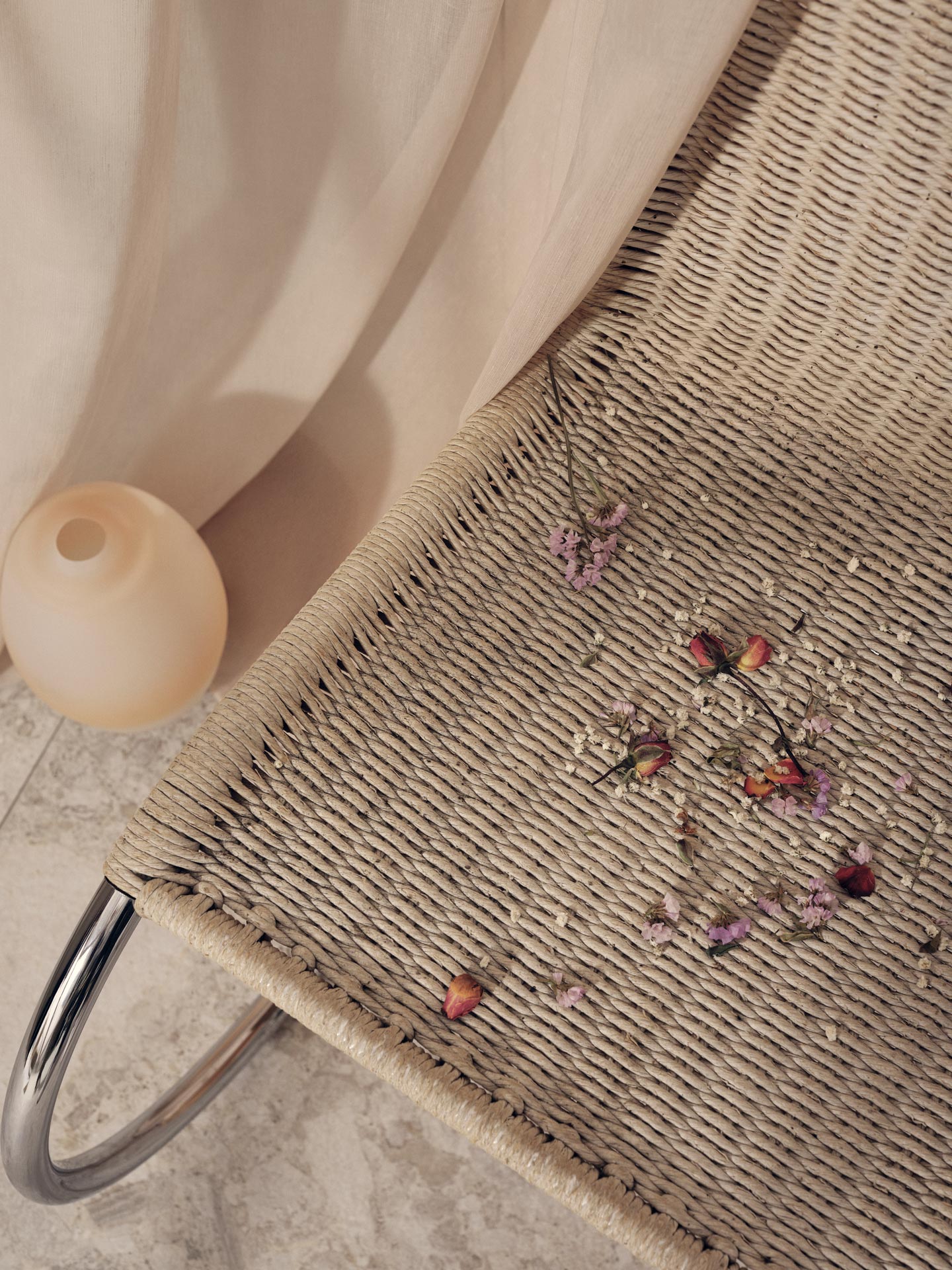 wicker chair covered in dried flowers for Jean-Paul Fortin summer-spring collection photographed by Maxyme G Delisle with artistic direction, conception and set design by Studio TB