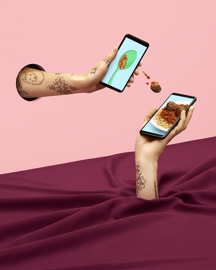 surrealist shot of meatballs being thrown from a mobile phone to another by Simon Duhamel for Fizz