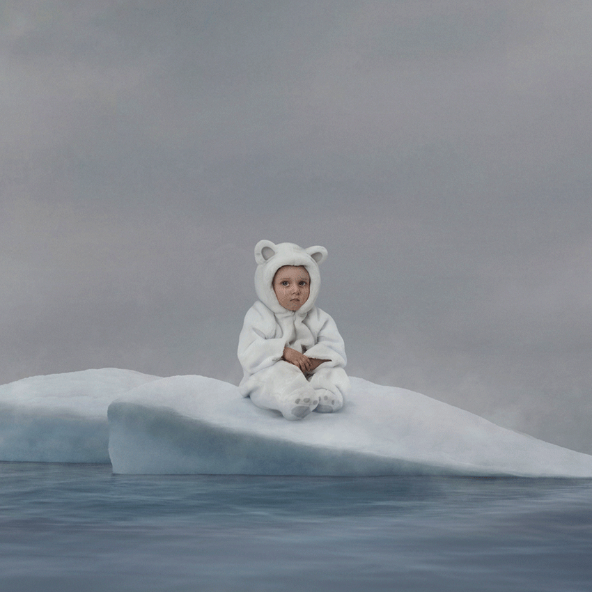 little boy dressed as polar bear crying on melting ice cap in middle of water by Simon Duhamel for Earth Day Lg2
