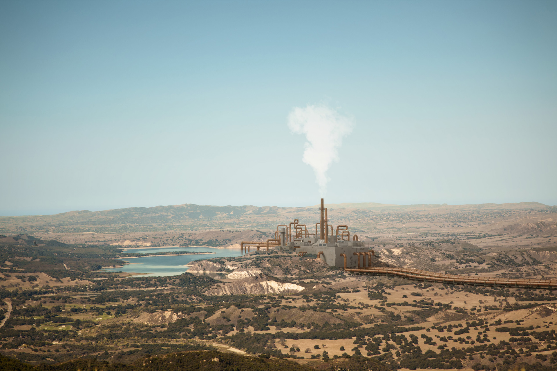 pipeline going through mountains to get to a fuming factory next to a lake by Simon Duhamel for Pipeline