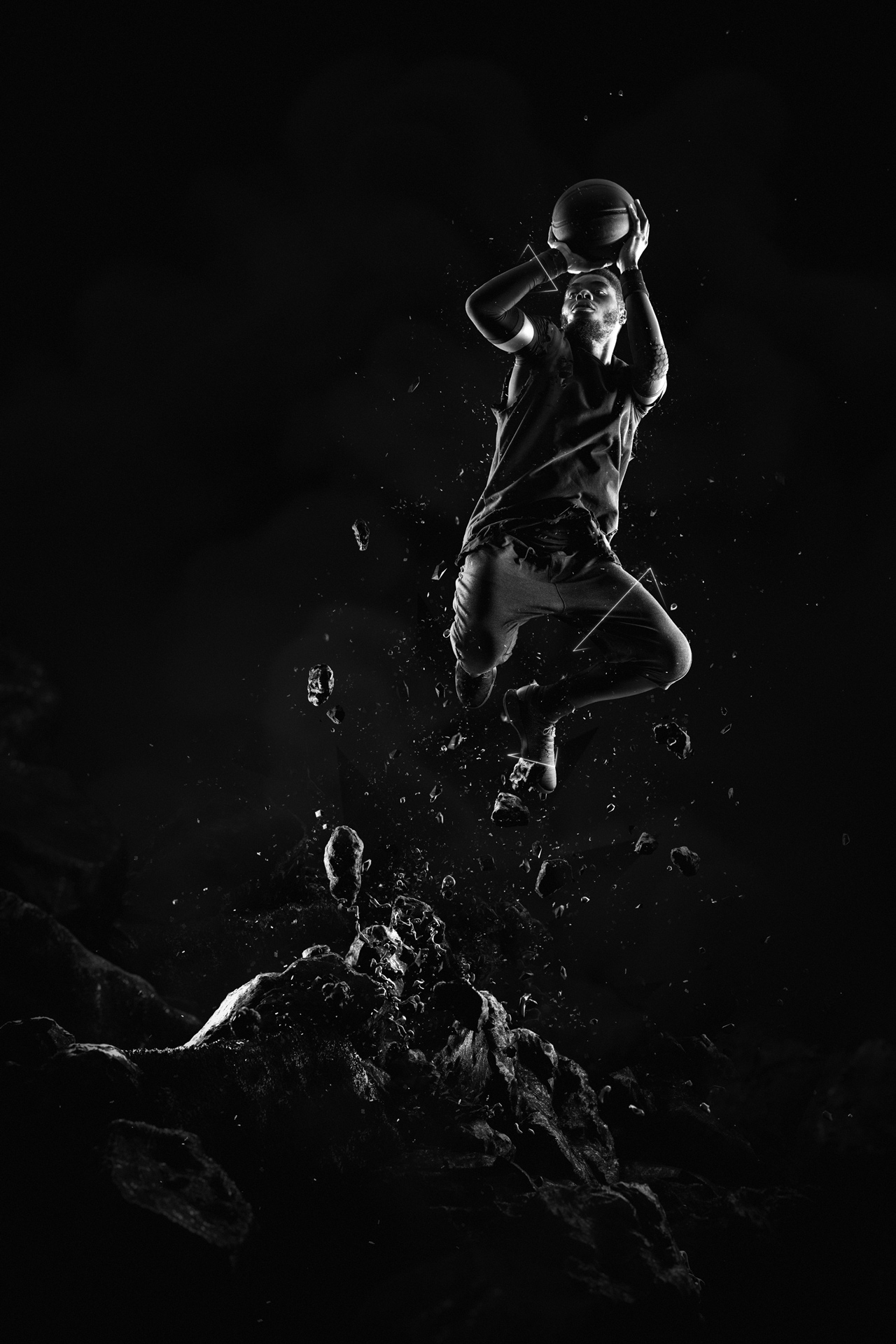 black man posing as basketball player jumping from the ground with debris around basket ball in hand trying to shoot low lighting black and white by Simon Duhamel for W-Hoop