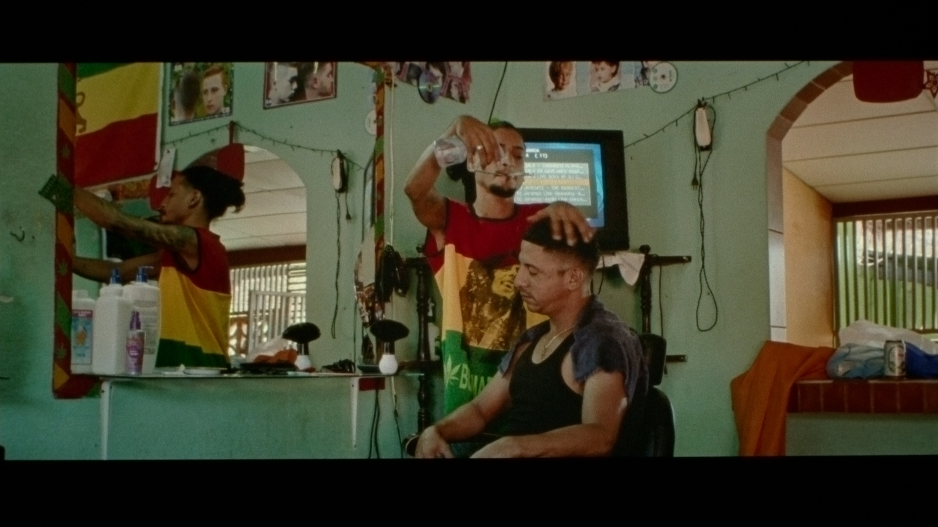 hairdresser working on man's head for singer Karim Ouellet music video of La Mer A Boire filmed by Les Gamins