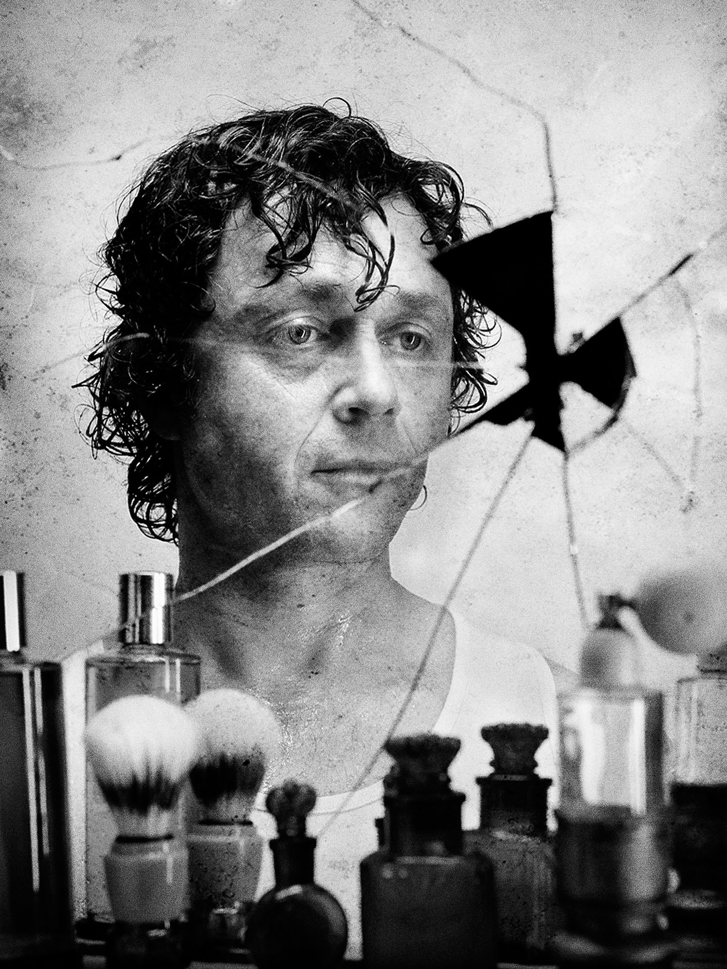 black and white portrait of Marc Beland in a broken mirror looking fresh out of the shower by Jocelyn Michel for Voir