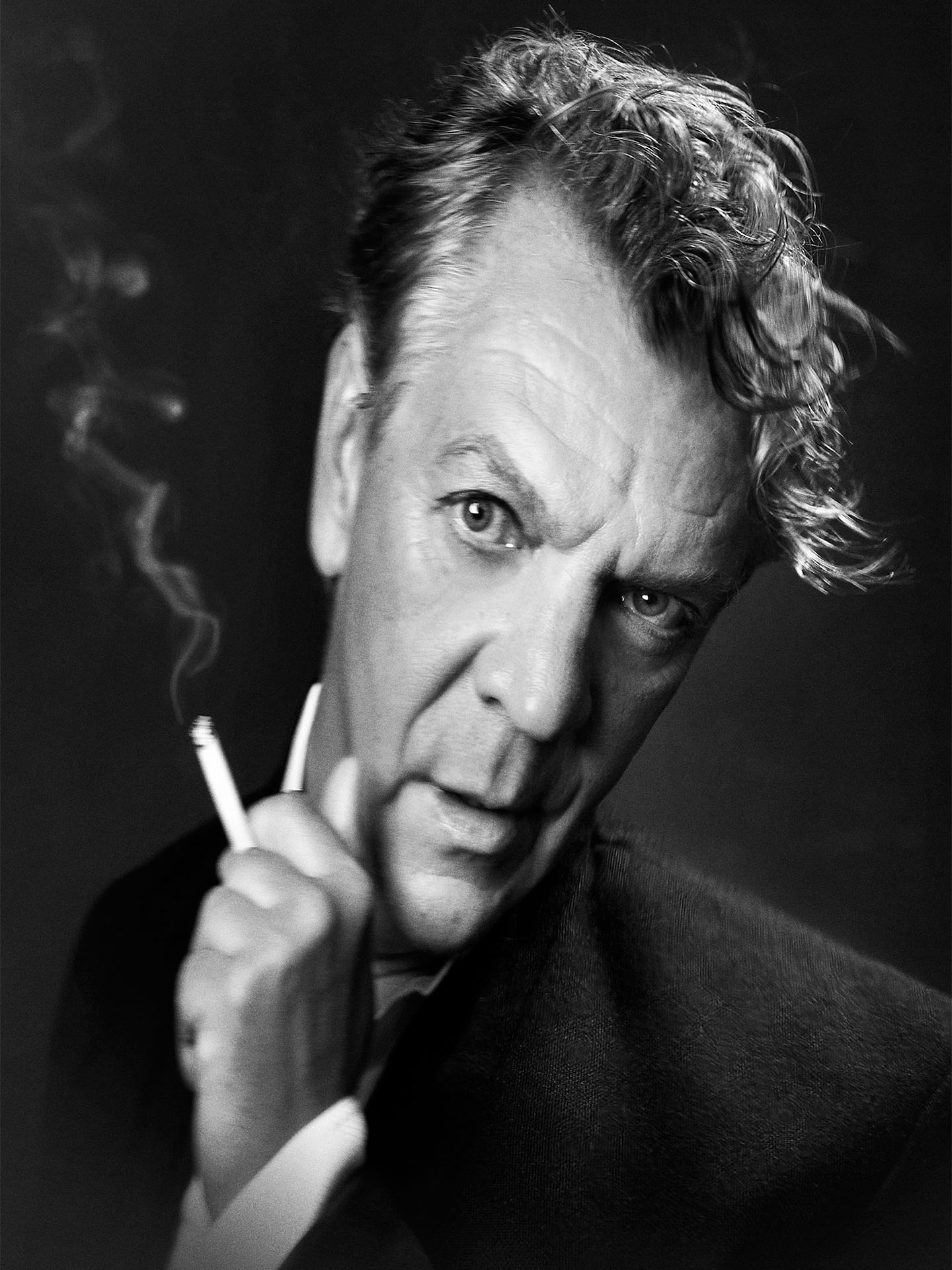 black and white distorted portrait of Marc Labreche holding a cigarette by Jocelyn Michel for Voir