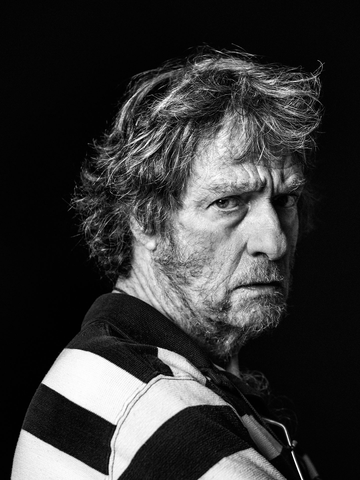 black and white portrait of Plume Latraverse on black background looking at camera by Jocelyn Michel for Voir