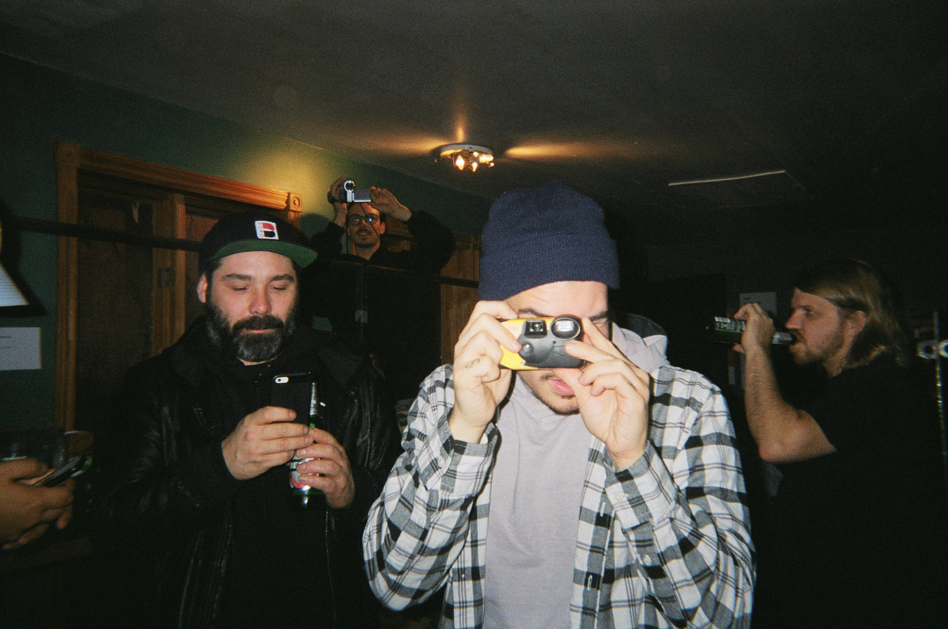 rapper Koriass taking picture with disposable camera in behind the scenes of L'Osstidfilm documentary filmed by Vincent Ruel-Cote from Les Gamins about L'Osstidtour